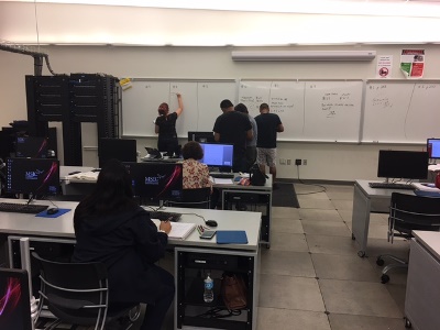 students working at white board in class
