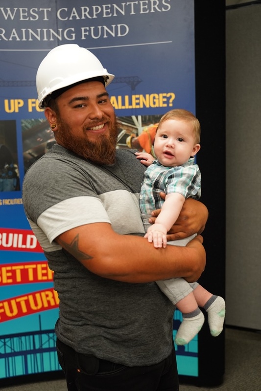 Martin Hernandez holding his youngest son